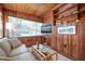 Inviting living room with wood-paneled walls and comfortable seating area at 1207 Magnolia St, New Smyrna Beach, FL 32168