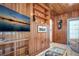 Relaxing living room, featuring built-in shelving and wood paneling at 1207 Magnolia St, New Smyrna Beach, FL 32168