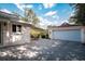 Outdoor patio with table and chairs, attached to garage at 1207 Magnolia St, New Smyrna Beach, FL 32168