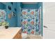 Bright blue bathroom with shower and beach decor at 121 Sedona Cir, Daytona Beach, FL 32124