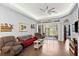 Living room with red couch, armchairs, and sliding glass doors at 121 Sedona Cir, Daytona Beach, FL 32124