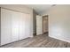 Bedroom with wood-look floors, large closet, and access to another room at 1210 Washington St, New Smyrna Beach, FL 32168