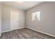 Bedroom with wood-look floors and white closet doors at 1210 Washington St, New Smyrna Beach, FL 32168