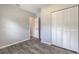 Bedroom with wood-look floors and white closet doors at 1210 Washington St, New Smyrna Beach, FL 32168