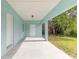 Covered patio with concrete flooring, and exterior door access at 1210 Washington St, New Smyrna Beach, FL 32168