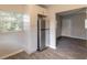 Stainless steel refrigerator and white cabinets in kitchen at 1210 Washington St, New Smyrna Beach, FL 32168