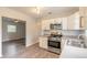 Updated kitchen featuring white cabinets and stainless steel appliances at 1210 Washington St, New Smyrna Beach, FL 32168