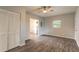 Bright living room, featuring wood-look floors and ceiling fan at 1210 Washington St, New Smyrna Beach, FL 32168