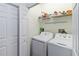 Laundry room with washer, dryer, and overhead shelving at 122 Turnbull Villas Cir, New Smyrna Beach, FL 32168