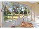 Sunroom with wicker furniture and view of grassy backyard at 122 Turnbull Villas Cir, New Smyrna Beach, FL 32168