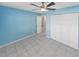 Empty bedroom with light blue walls, tiled floors and double closets at 1253 Harbour Point Dr, Port Orange, FL 32127