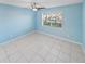 Empty bedroom with light blue walls and tiled floors at 1253 Harbour Point Dr, Port Orange, FL 32127