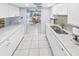 White kitchen with granite counters and view into dining area at 1253 Harbour Point Dr, Port Orange, FL 32127