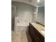 Bright bathroom with double vanity, granite countertops, tub and glass-door shower at 126 Vista Verdi Cir # 204, Lake Mary, FL 32746