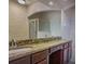 Bathroom features double sinks, granite countertop, wooden cabinets, and a glass-door shower at 126 Vista Verdi Cir # 204, Lake Mary, FL 32746