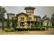Stately home exterior featuring fountain, tower, mature trees, and landscaped grounds at 126 Vista Verdi Cir # 204, Lake Mary, FL 32746