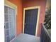 Orange patio showcasing the black front door and sliding glass door at 126 Vista Verdi Cir # 204, Lake Mary, FL 32746