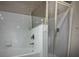 Clean, minimalist white shower with glass door and chrome fixtures at 126 Vista Verdi Cir # 204, Lake Mary, FL 32746