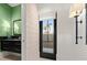 Stylish powder room with dark vanity, green walls, and a modern door at 1309 Hill St, New Smyrna Beach, FL 32169