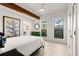 Bright bedroom with a green accent wall and large windows at 1309 Hill St, New Smyrna Beach, FL 32169