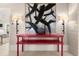 Bright entryway with red console table and modern art at 1309 Hill St, New Smyrna Beach, FL 32169