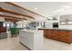 Modern kitchen with white cabinets, wood island, and green pendant lights at 1309 Hill St, New Smyrna Beach, FL 32169