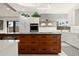 Modern kitchen with white cabinets, wood island, and stylish geometric wallpaper at 1309 Hill St, New Smyrna Beach, FL 32169