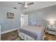 Charming bedroom with a queen bed, wood floors, and a view into the kitchen area at 142 Jean Francis Ln, Port Orange, FL 32127