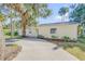 House exterior showcasing a light yellow facade, landscaping, and driveway at 142 Jean Francis Ln, Port Orange, FL 32127