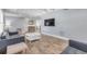 Living room with gray sofas, wood-look floors, vaulted ceilings, and a view of the kitchen at 142 Jean Francis Ln, Port Orange, FL 32127