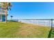 Oceanfront property with grassy area and white fence at 1571 S Atlantic Ave # 4110, New Smyrna Beach, FL 32169