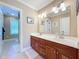 Double vanity bathroom with updated fixtures and tile flooring at 182 Kentucky Blue Cir, Apopka, FL 32712