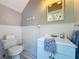 Small bathroom with white vanity, toilet and beadboard wainscoting at 182 Kentucky Blue Cir, Apopka, FL 32712