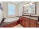 Relaxing bathroom with soaking tub, granite vanity, and ample storage at 182 Kentucky Blue Cir, Apopka, FL 32712