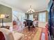 Elegant dining room with hardwood floors, piano, and chandelier at 182 Kentucky Blue Cir, Apopka, FL 32712