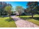 Brick driveway to a two-story house with attached garage at 182 Kentucky Blue Cir, Apopka, FL 32712