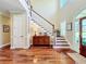 Two-story foyer with hardwood floors and elegant staircase at 182 Kentucky Blue Cir, Apopka, FL 32712