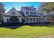 Two-story yellow house with a wraparound porch and landscaped lawn at 182 Kentucky Blue Cir, Apopka, FL 32712