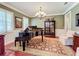 Music room with grand piano, chandelier, and hardwood floors at 182 Kentucky Blue Cir, Apopka, FL 32712