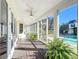 Long screened porch with wooden flooring and lush greenery at 182 Kentucky Blue Cir, Apopka, FL 32712