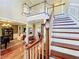 Grand staircase with a chandelier and hardwood floors at 182 Kentucky Blue Cir, Apopka, FL 32712