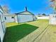 Large grassy backyard with shed and home at 2101 Oriole Ln, South Daytona, FL 32119