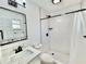 Bright bathroom featuring a stylish vanity, tiled shower, and modern fixtures for a clean aesthetic at 2101 Oriole Ln, South Daytona, FL 32119