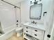 This bathroom features a modern vanity, marble countertops, black fixtures, and a tiled shower/tub combo at 2101 Oriole Ln, South Daytona, FL 32119