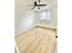 A simple bedroom features wood-look flooring, curtains over the windows, and white walls at 2101 Oriole Ln, South Daytona, FL 32119