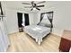 Bright bedroom with a queen-size bed and light wood floors at 2101 Oriole Ln, South Daytona, FL 32119