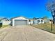 Charming single-story home featuring a well-maintained front yard, gray garage door, and a concrete driveway at 2101 Oriole Ln, South Daytona, FL 32119