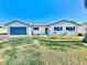 Newly renovated home exterior with a blue garage door at 2101 Oriole Ln, South Daytona, FL 32119