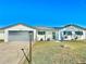 Newly renovated home with gray garage door at 2101 Oriole Ln, South Daytona, FL 32119