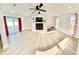 Expansive living room with wood floors, fireplace, and access to the backyard and ample natural light at 2101 Oriole Ln, South Daytona, FL 32119